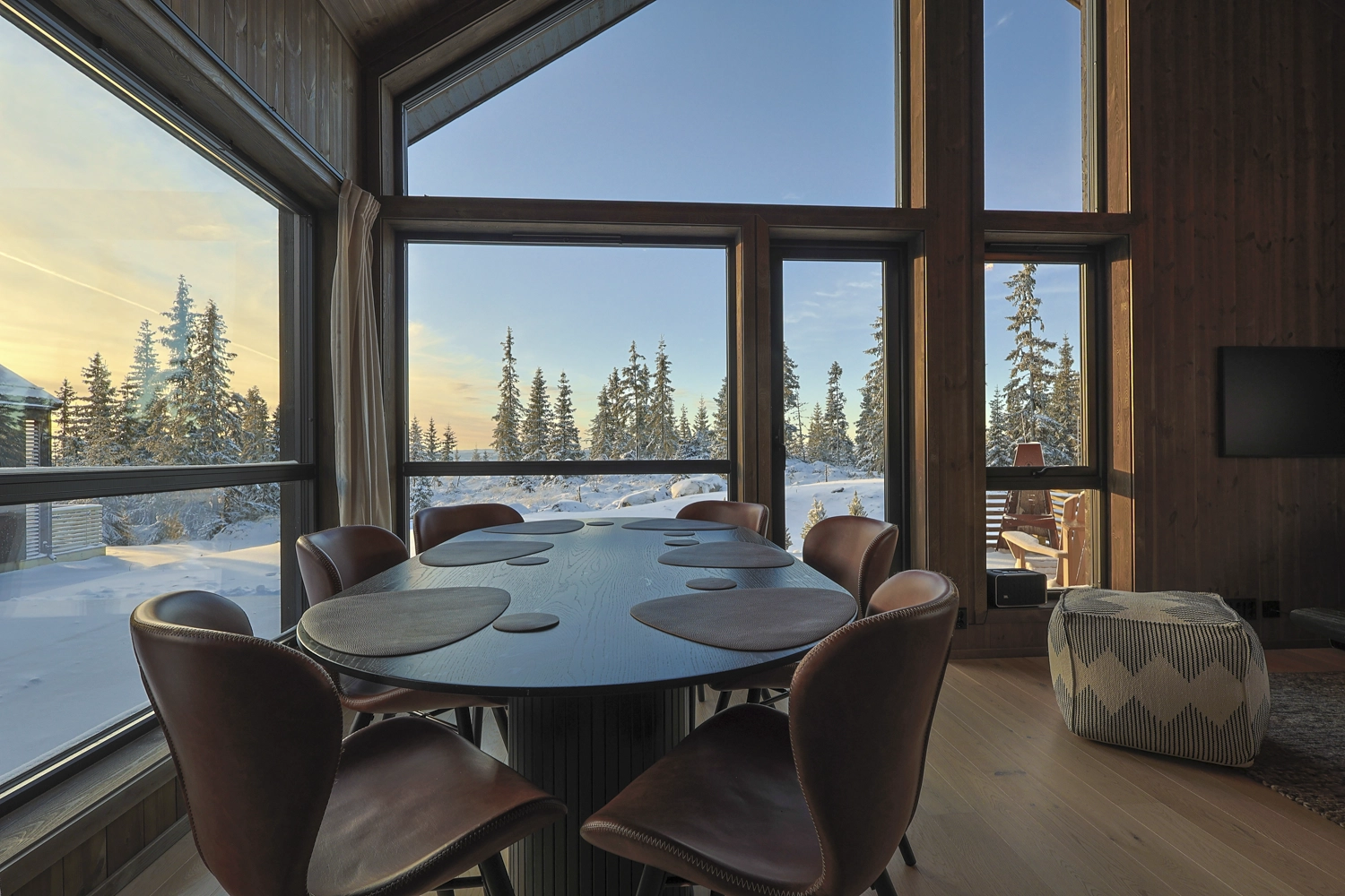 Dining area with view of pine forest and snow