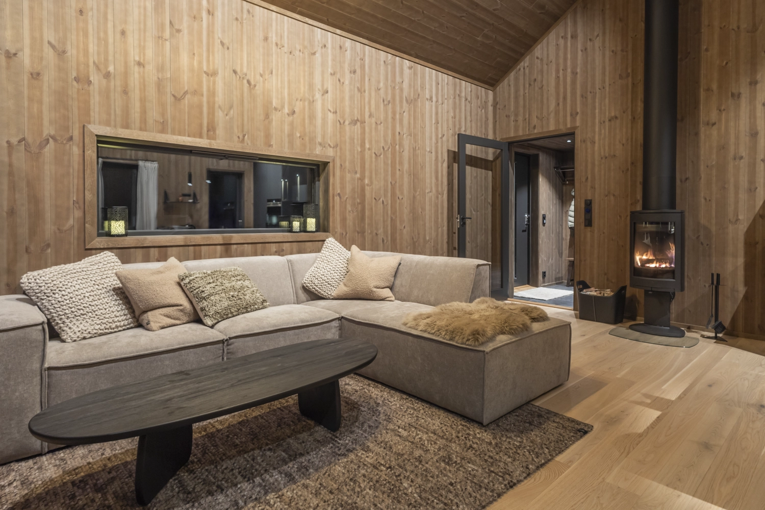 Cozy modern living room with indoor fireplace in Hafjell cabin